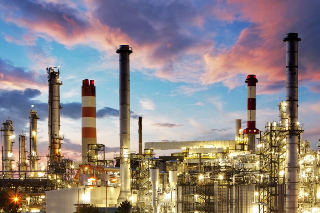 Industrial refinery complex at dusk with illuminated processing units